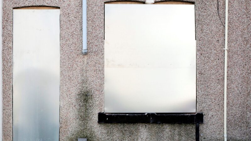 A property with metal screens at the window and door